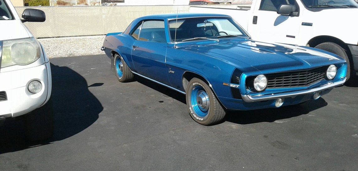 A blue car parked in the parking lot.