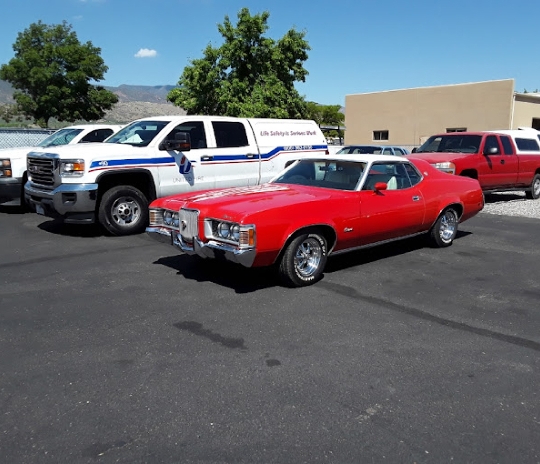 A red car parked in the parking lot of a business.